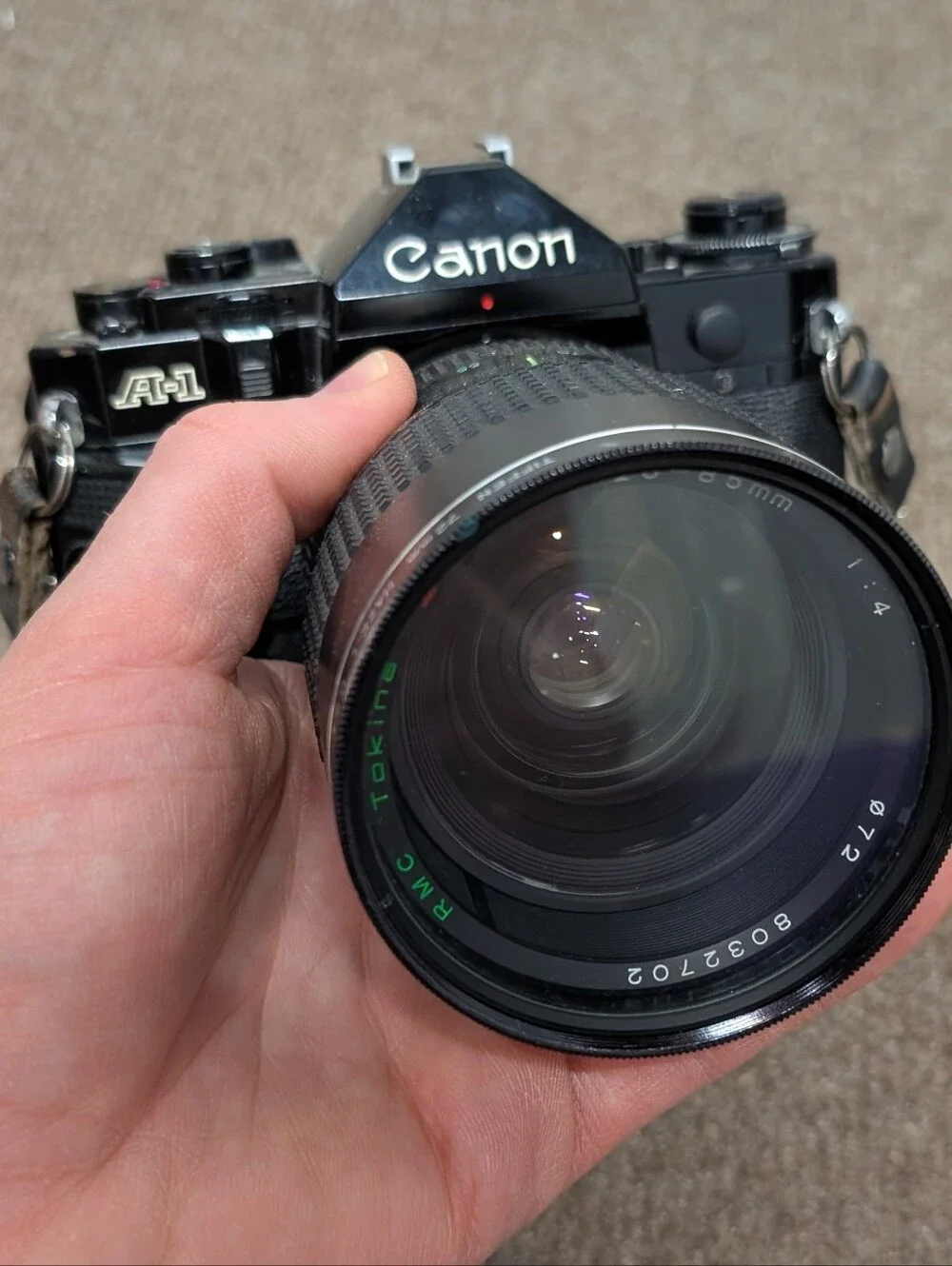 Vintage Canon A-1 Black SLR Camera with Black Lens and Black Flash